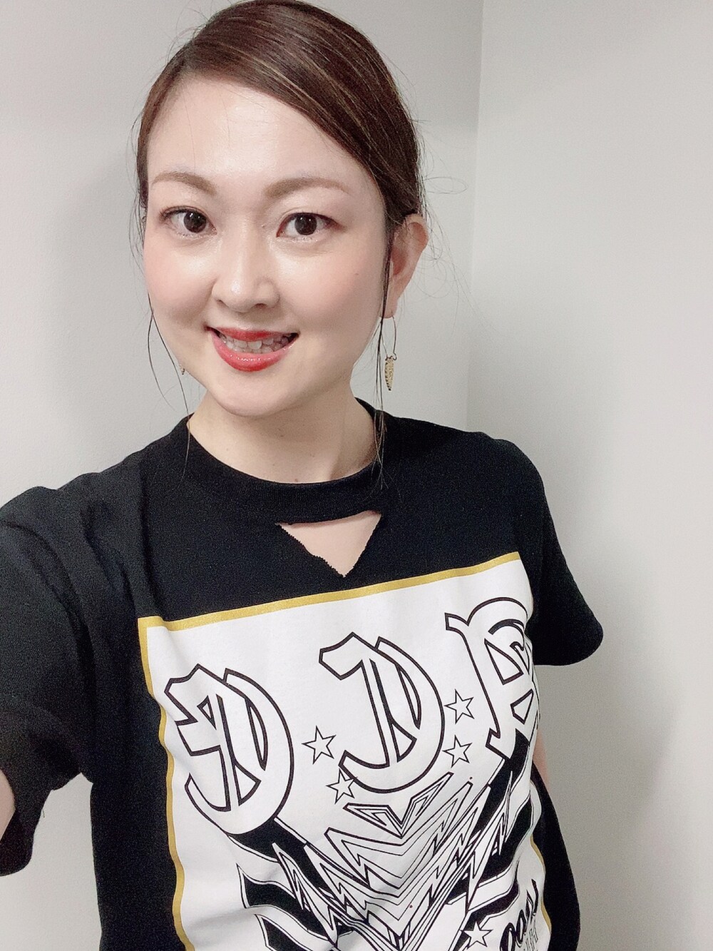 ブラック系のTシャツ/カットソー、ホワイト系のスカート、ホワイト系のサンダルを着用したレディースの夏コーディネートの4枚目の写真