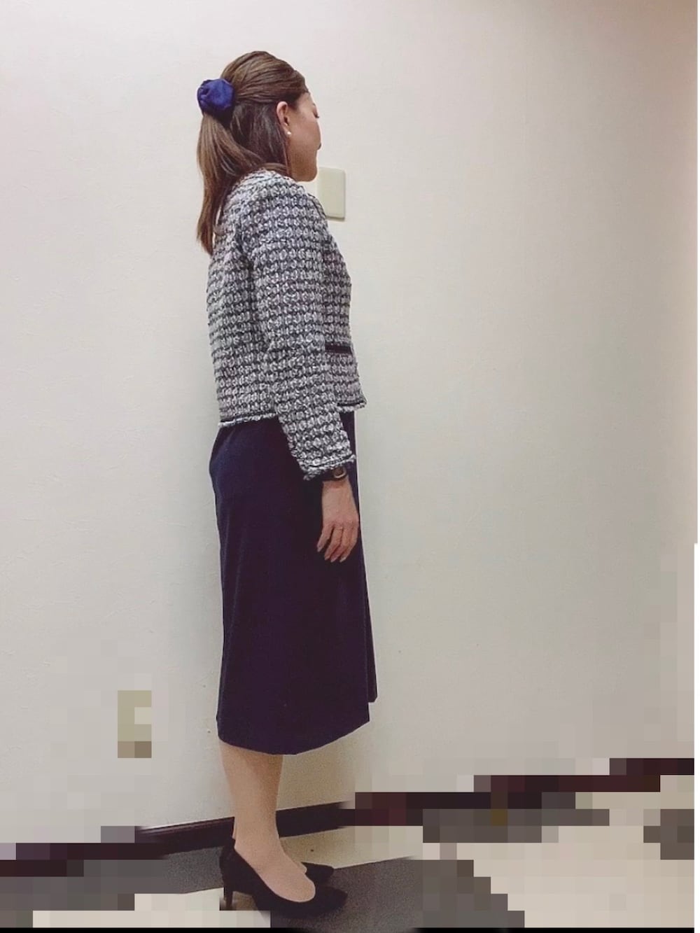 ブルー系のスーツセット、ブラック系のパンプス、ホワイト系のネックレスを着用したレディースの冬コーディネートの3枚目の写真