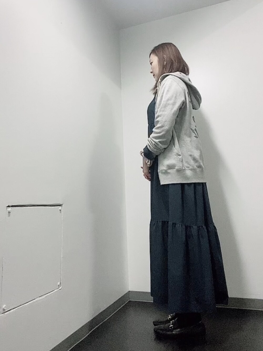 ブルー系のワンピース、ブラック系のローファー、グレー系のパーカーを着用したレディースの秋コーディネートの4枚目の写真