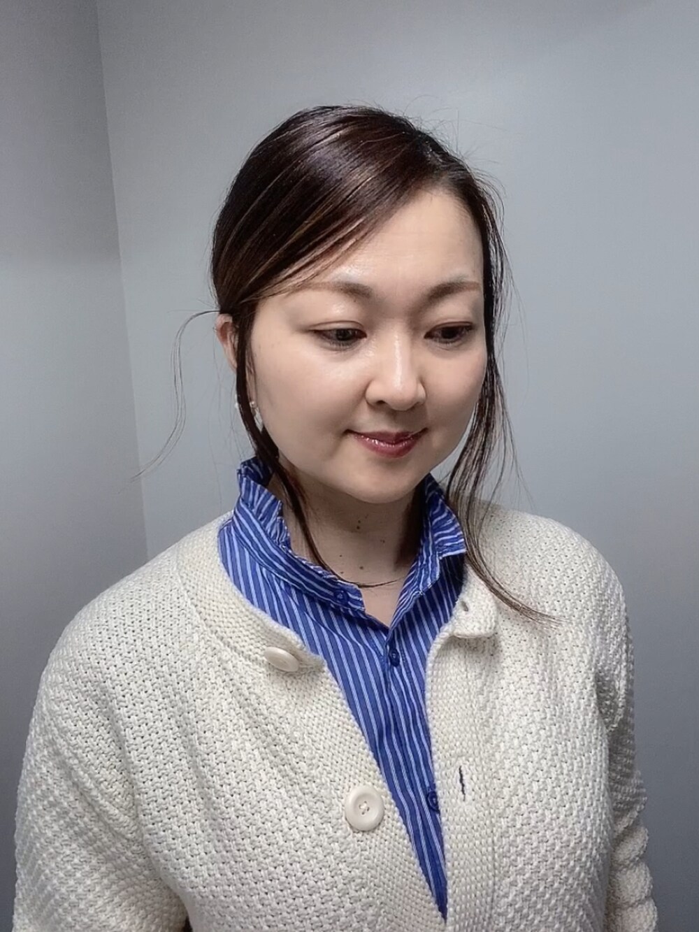 ホワイト系のカーディガン/ボレロ、ブルー系のシャツ/ブラウス、ブルー系のデニムパンツを着用したレディースの冬コーディネートの4枚目の写真