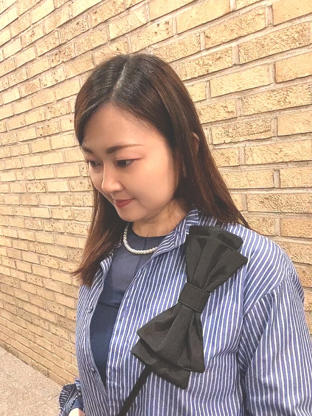 ブルー系のTシャツ/カットソー、ブルー系のシャツ/ブラウス、ブラック系のスラックスを着用したレディースの春コーディネートの5枚目の写真