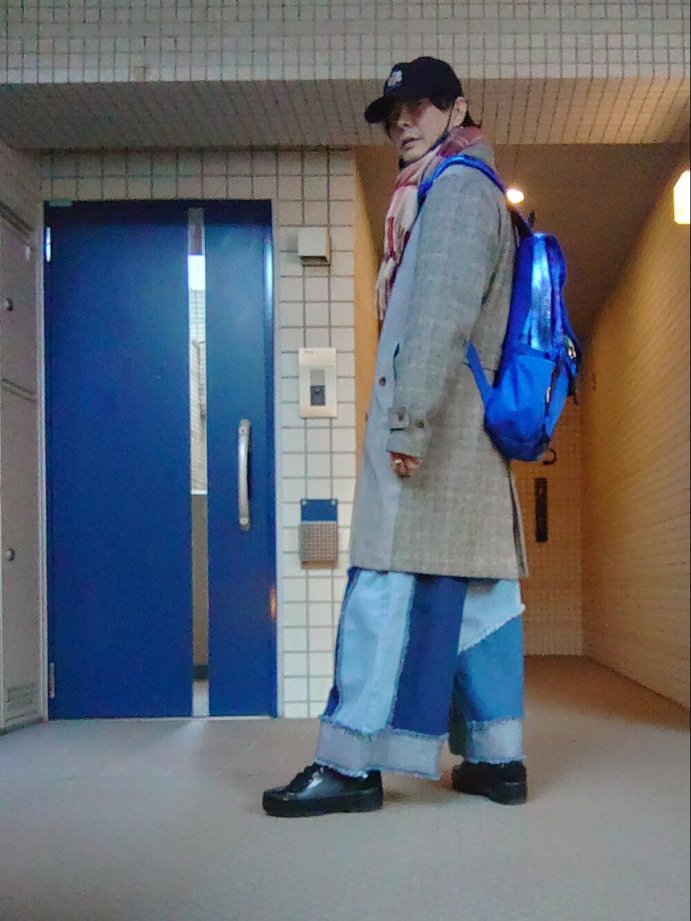 ブルー系のデニムパンツ、ブラック系のスニーカーを着用したメンズの冬コーディネートの2枚目の写真