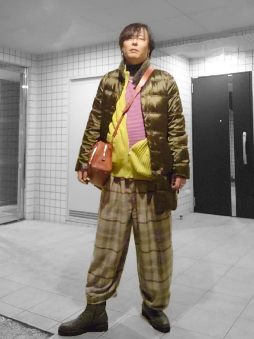 イエロー系のベスト、ピンク系のTシャツ/カットソー、ベージュ系のその他パンツを着用したメンズの冬コーディネートの2枚目の写真