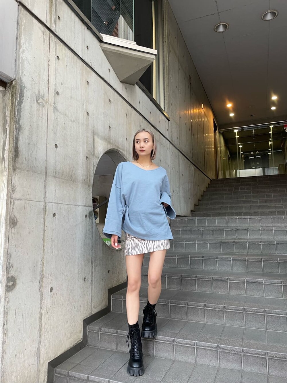 その他のスカート、ブラック系のブーツ、ブルー系のTシャツ/カットソーを着用したレディースの冬コーディネートの2枚目の写真