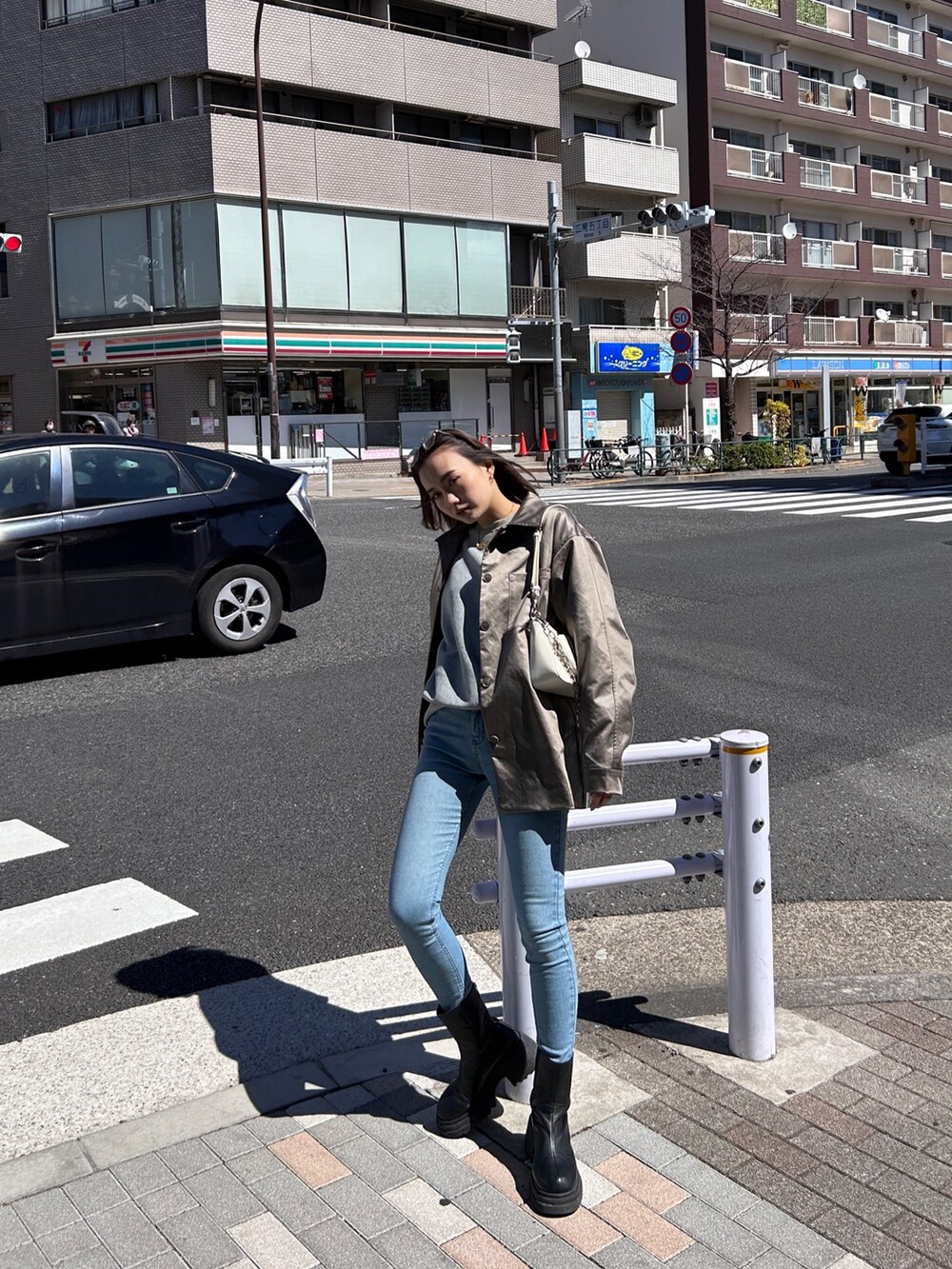 ブルー系のデニムパンツ、ブラック系のジャケット/アウター、ブラック系のブーツを着用したレディースの春コーディネートの2枚目の写真