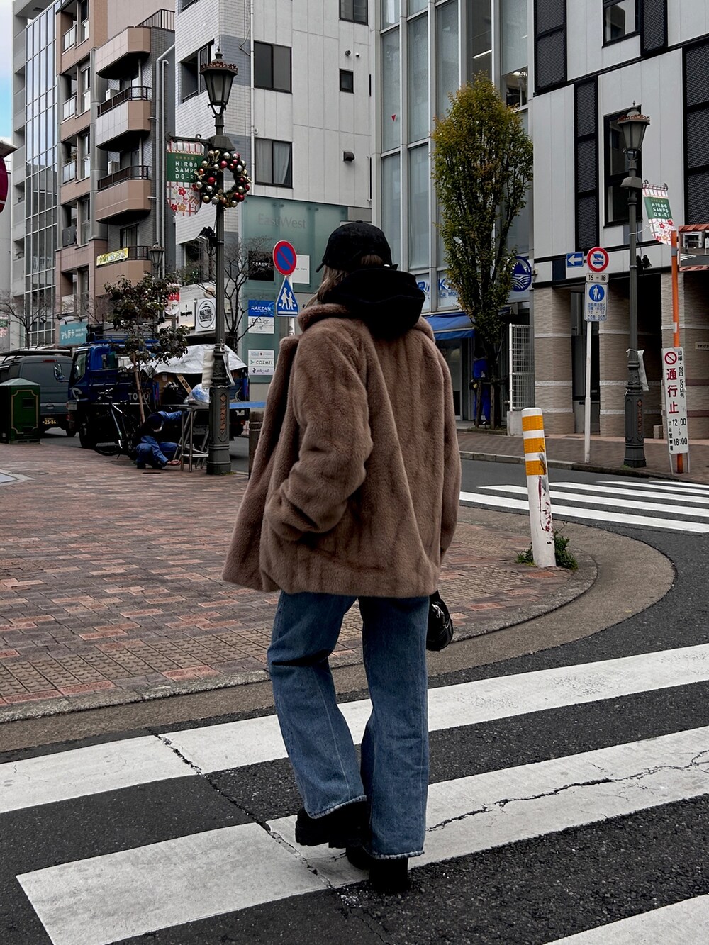 ベージュ系のその他アウター、ブラック系のハンドバッグ、ブラック系のブーツを着用したレディースの冬コーディネートの2枚目の写真