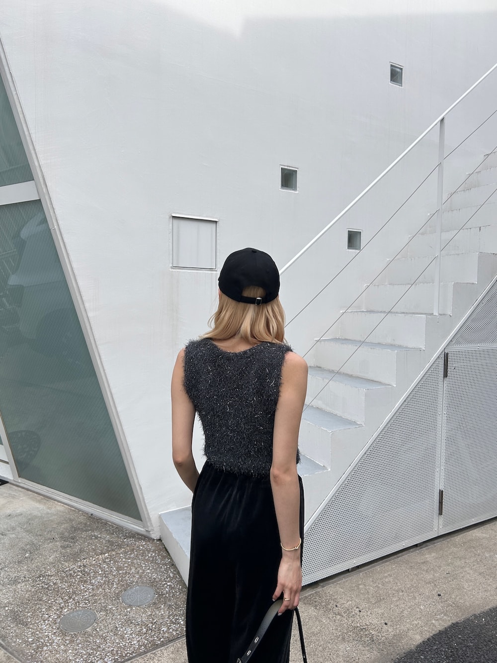 グレー系のタンクトップ、ブラック系のその他パンツ、ブラック系のハンドバッグを着用したレディースの夏コーディネートの3枚目の写真