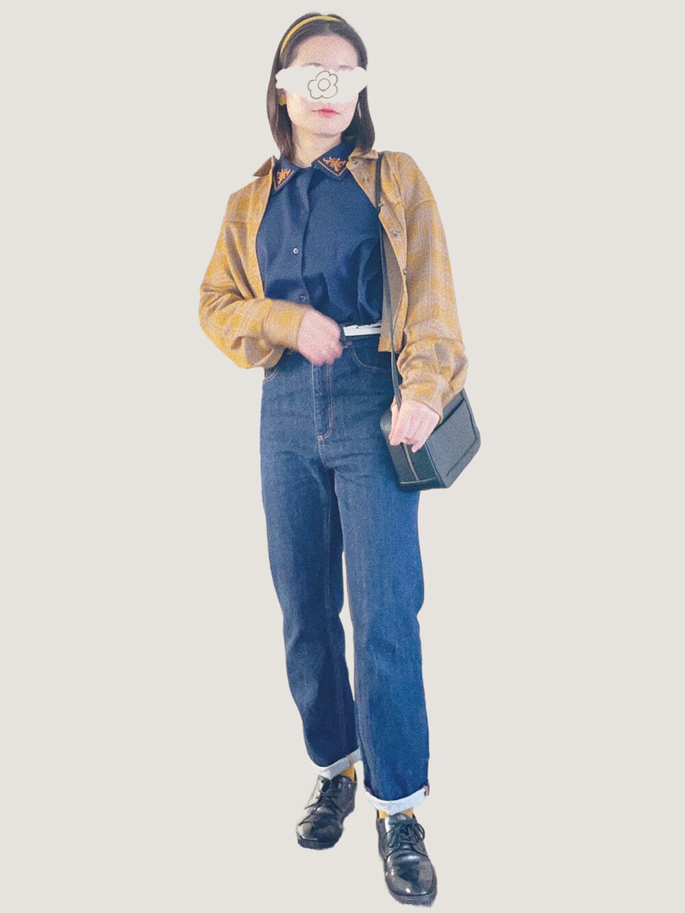 ブルー系のデニムパンツ、ブラック系のショルダーバッグ、ブラック系のドレスシューズを着用したレディースの冬コーディネートの3枚目の写真