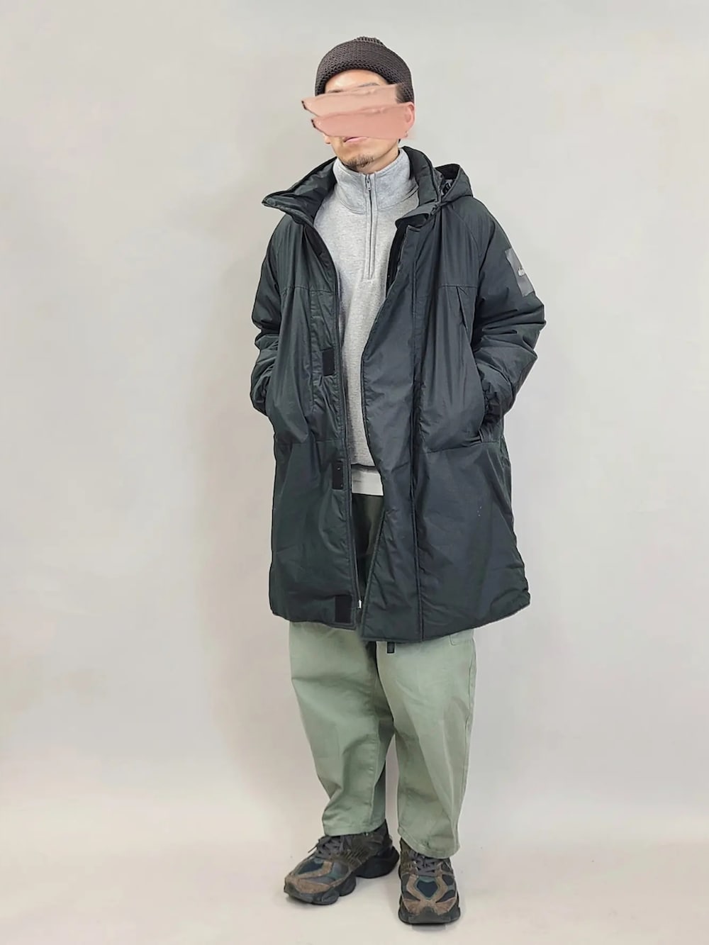 ブラック系のダウンジャケット/コート、グリーン系のカーゴパンツ、ブラウン系のスニーカーを着用したメンズの冬コーディネートの2枚目の写真