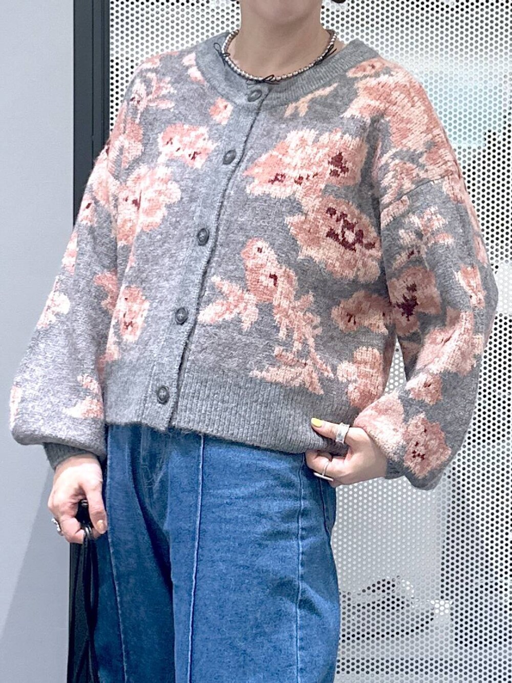 ブラック系のショルダーバッグ、ブルー系のデニムパンツ、グレー系のカーディガン/ボレロを着用したレディースの秋コーディネートの5枚目の写真