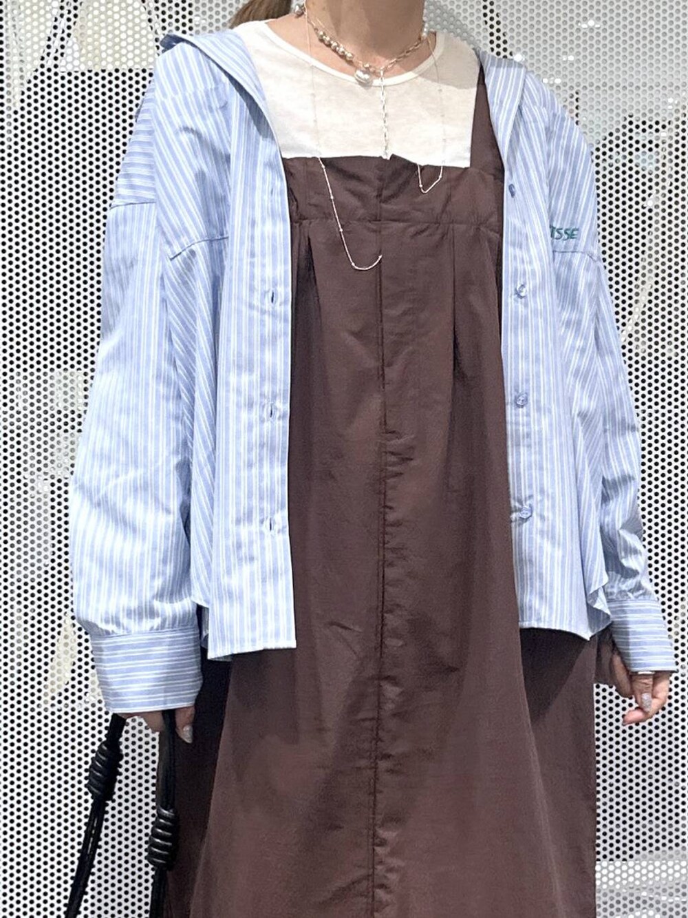 ホワイト系のTシャツ/カットソー、ブラック系のスニーカー、ブラック系のショルダーバッグを着用したレディースの秋コーディネートの4枚目の写真