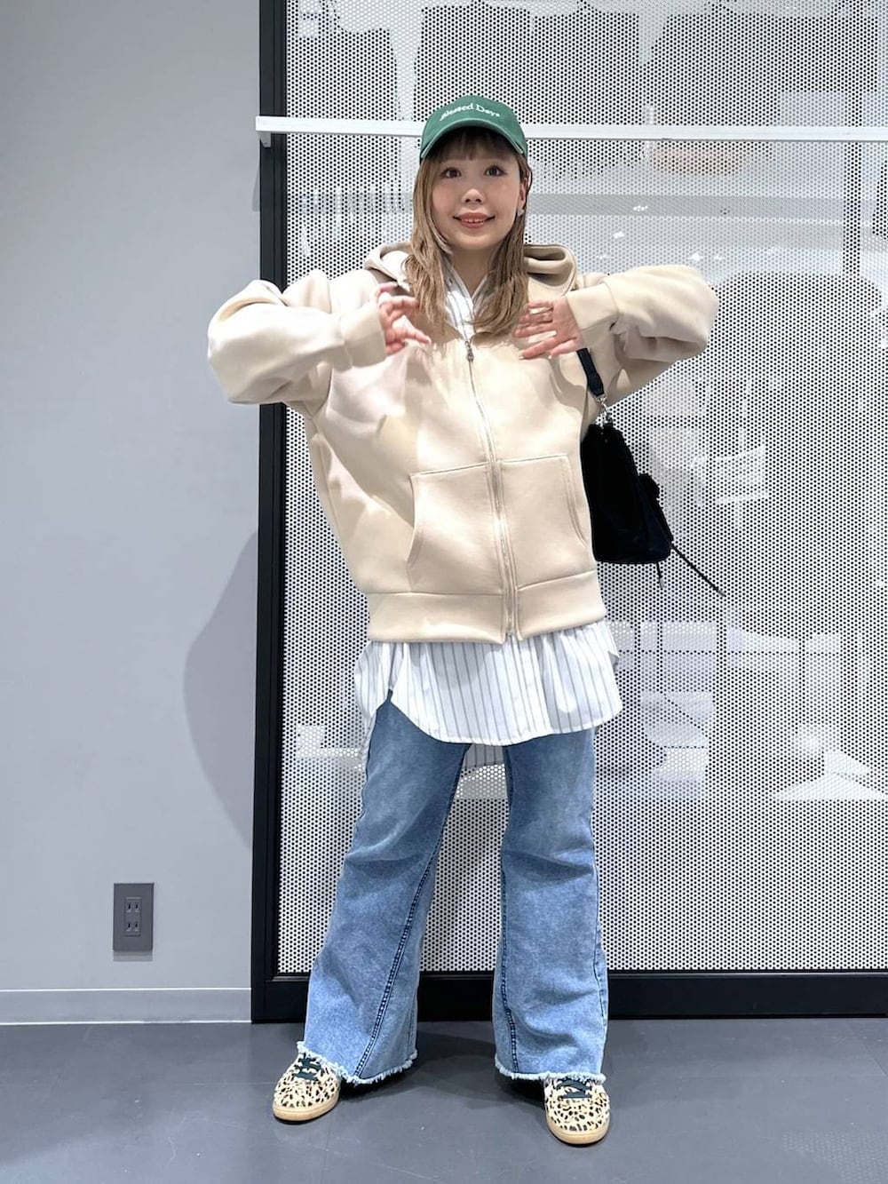 ホワイト系のシャツ/ブラウス、ブラック系のショルダーバッグ、ブルー系のデニムパンツを着用したレディースの春コーディネートの5枚目の写真