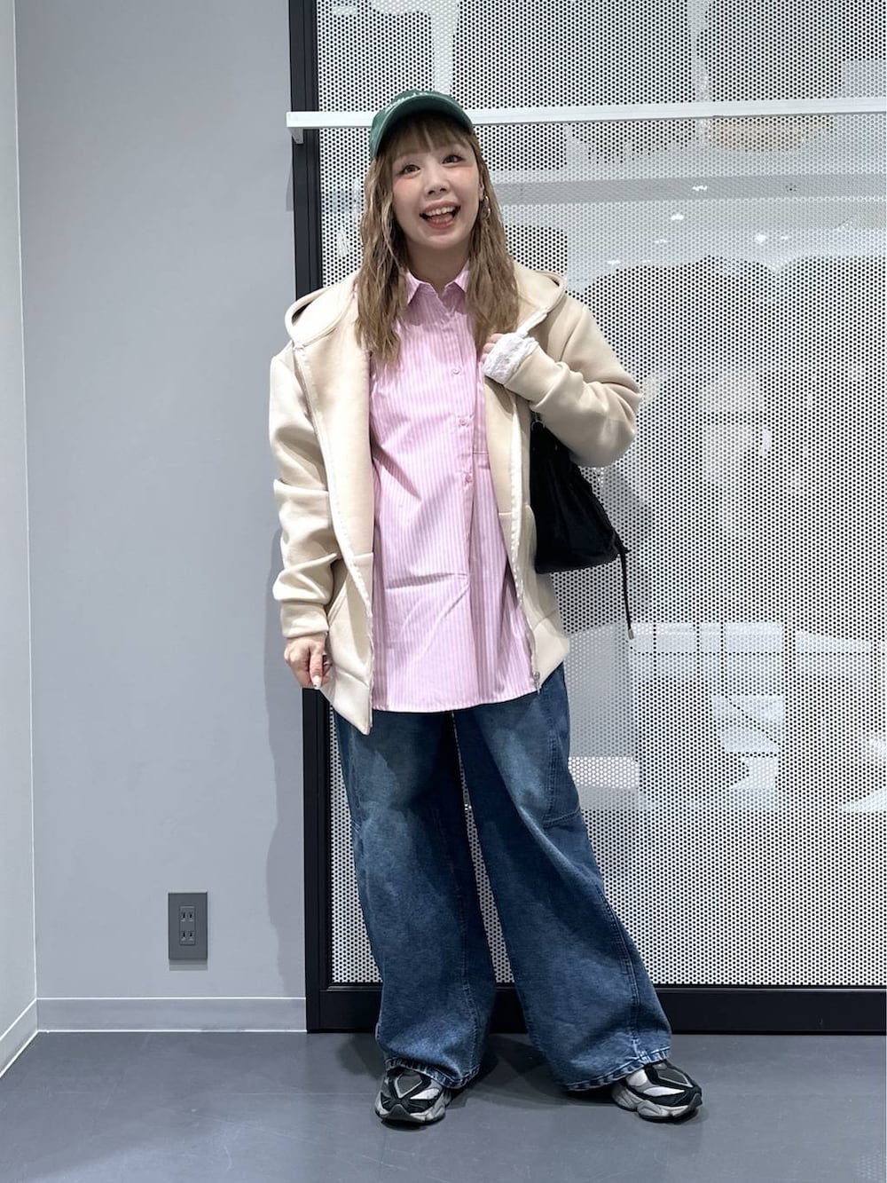 ホワイト系のTシャツ/カットソー、ブラック系のショルダーバッグ、ブルー系のデニムパンツを着用したレディースの冬コーディネートの7枚目の写真