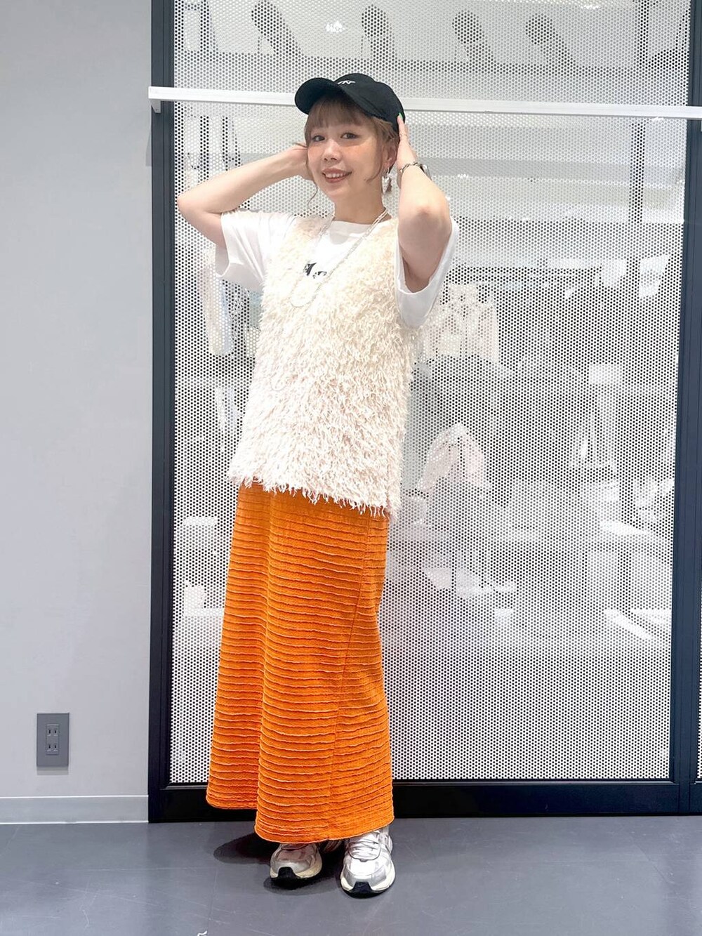 ブラック系のショルダーバッグ、ホワイト系のベスト、ホワイト系のTシャツ/カットソーを着用したレディースの春コーディネートの6枚目の写真