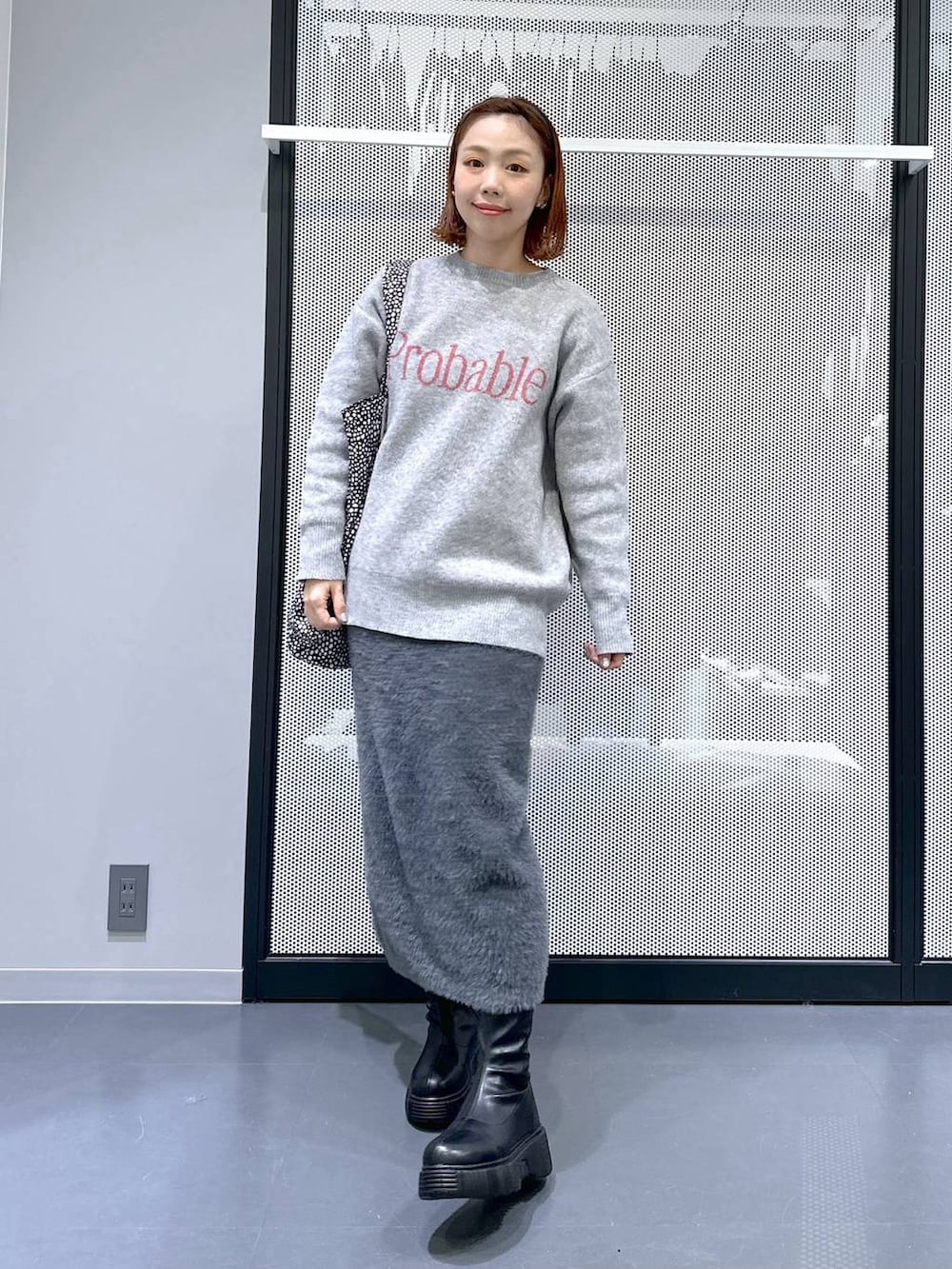 ブラック系のトートバッグ、ブラック系のブーツ、ブラック系のブルゾンを着用したレディースの冬コーディネートの7枚目の写真