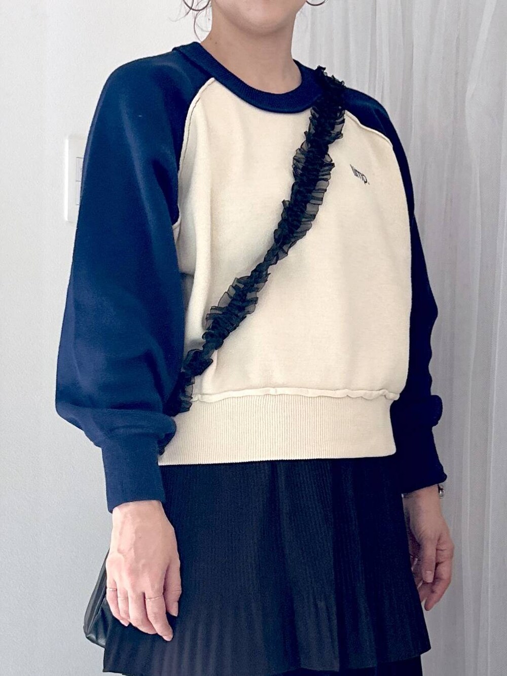 ブラック系のスカート、グレー系のスニーカー、ブルー系のニット/セーターを着用したレディースの秋コーディネートの4枚目の写真