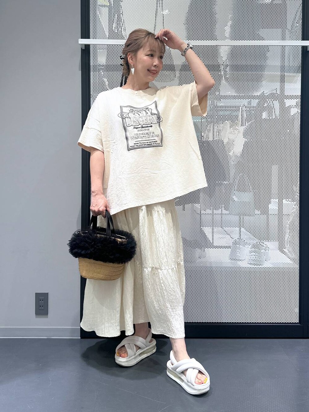 ベージュ系のショルダーバッグ、ホワイト系のスカート、ブラック系のバレッタ/ヘアクリップを着用したレディースの夏コーディネートの2枚目の写真