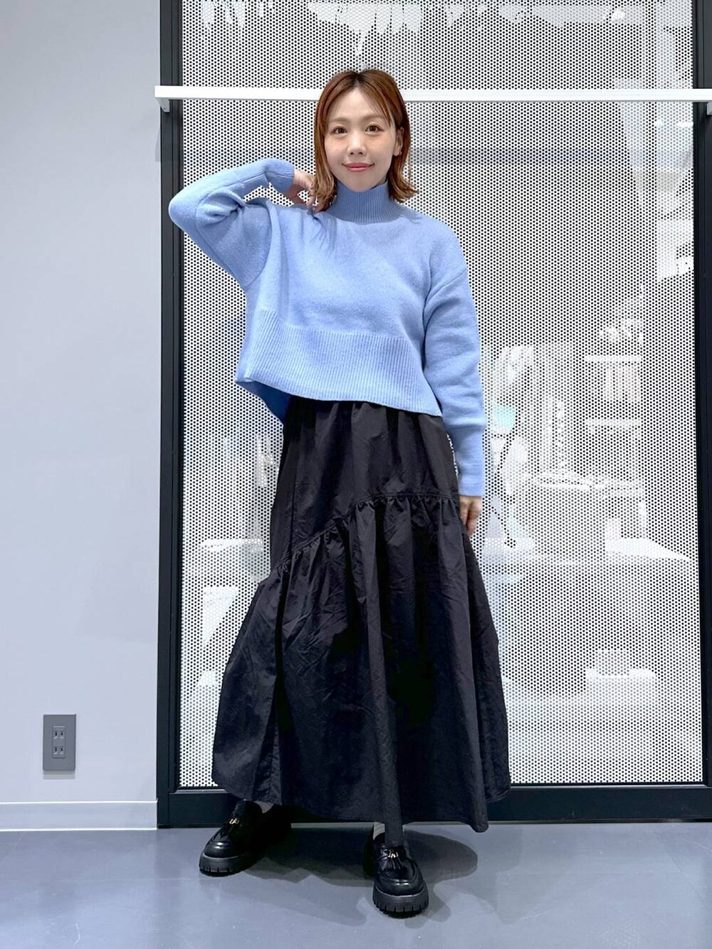 ホワイト系のショルダーバッグ、ブラック系のローファー、ベージュ系のブルゾンを着用したレディースの冬コーディネートの3枚目の写真