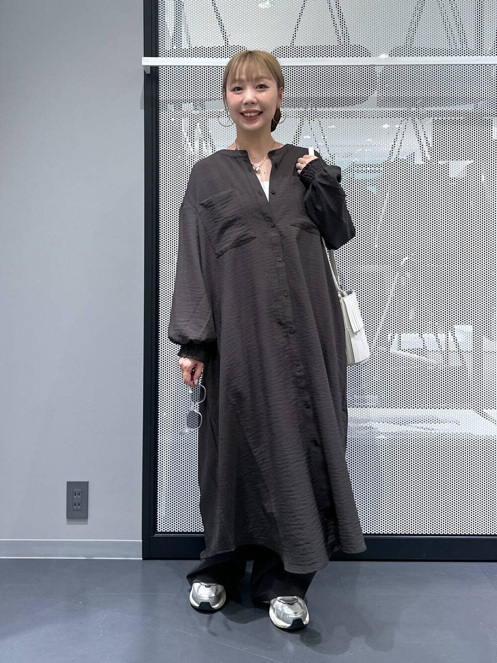 グレー系のその他パンツ、ホワイト系のタンクトップ、ホワイト系のショルダーバッグを着用したレディースの秋コーディネートの5枚目の写真