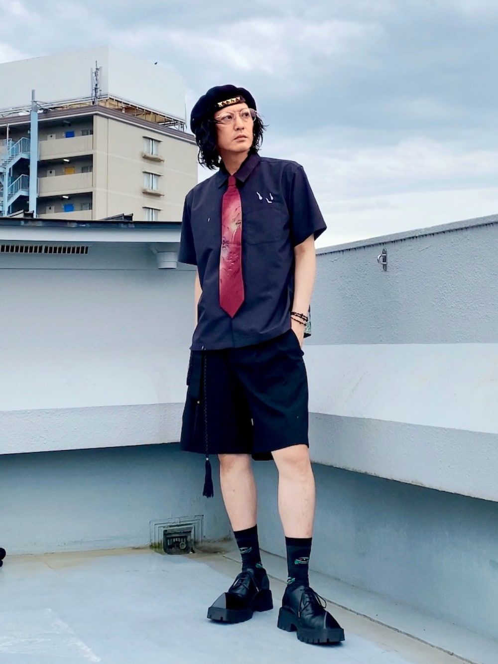 ブラック系のスラックス、ブラック系のシャツ/ブラウス、レッド系のネクタイを着用したメンズの夏コーディネートの2枚目の写真