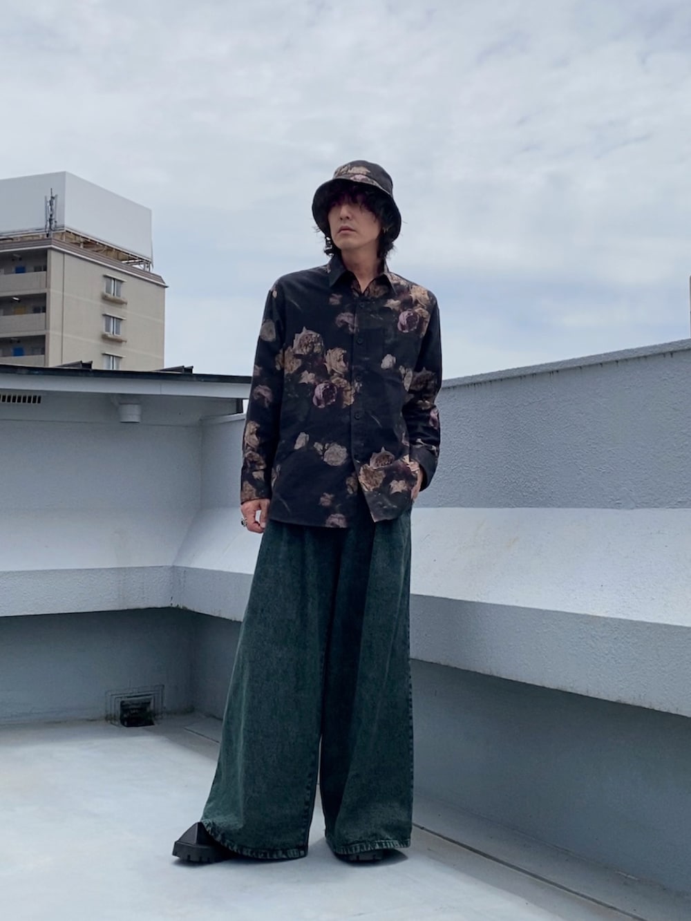 ブラック系のシャツ/ブラウス、ブラック系のタンクトップ、グリーン系のデニムパンツを着用したメンズの春コーディネートの2枚目の写真