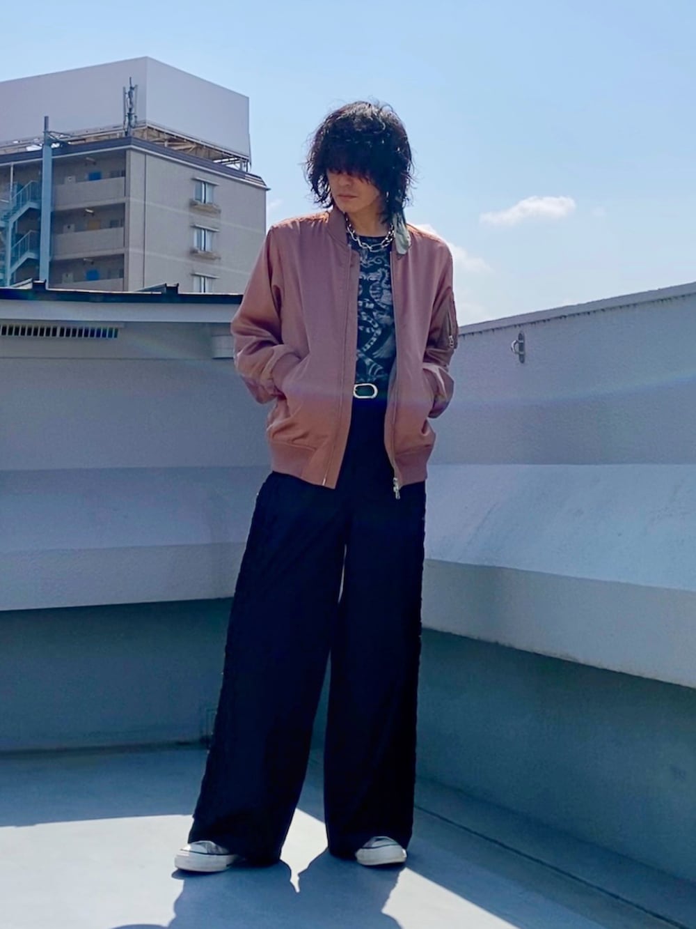 ピンク系のMA-1、ブラック系のTシャツ/カットソー、ブラック系のパンツを着用したメンズの春コーディネートの4枚目の写真