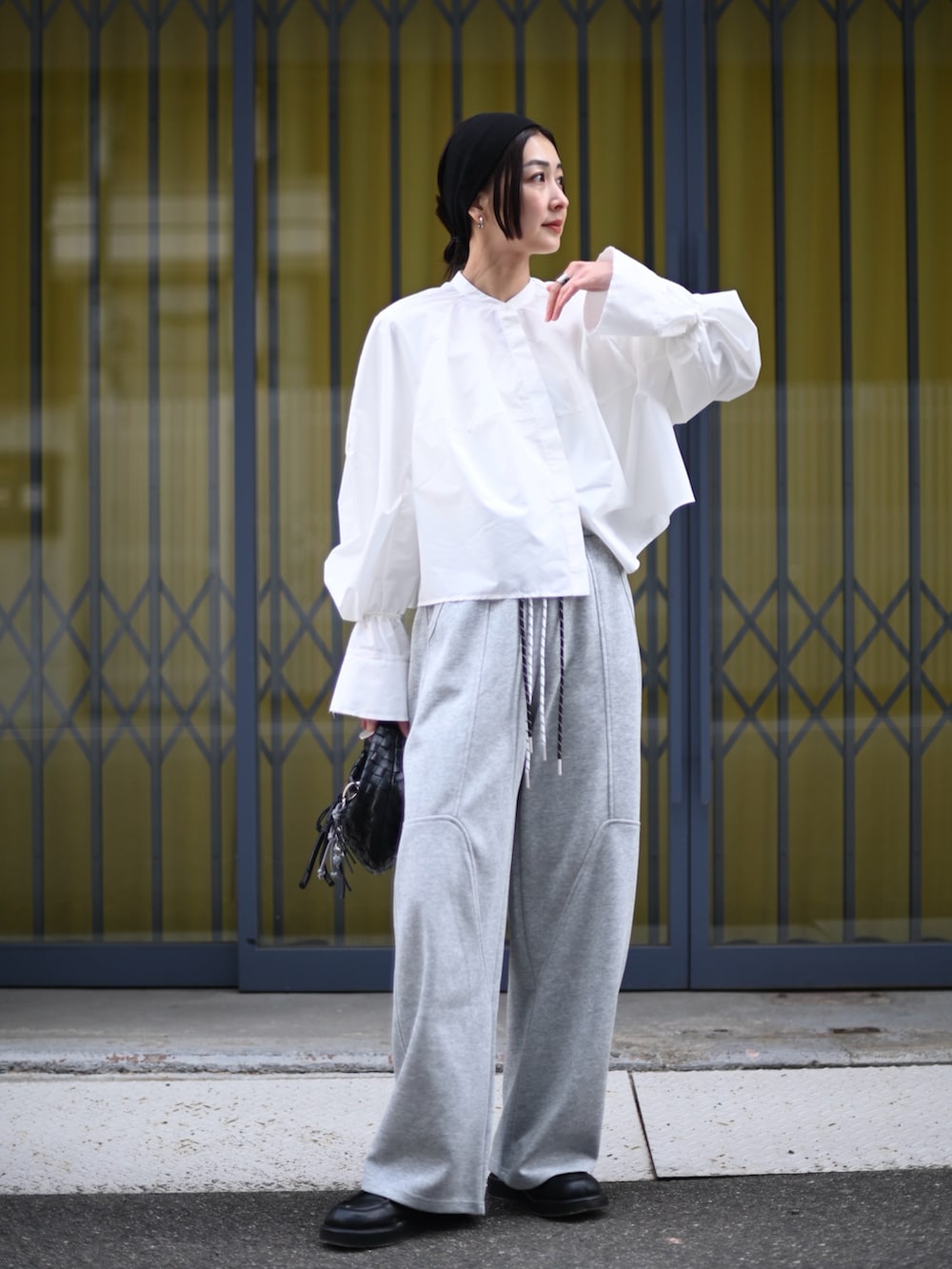 ホワイト系のシャツ/ブラウス、グレー系のスウェットパンツ、ブラック系のローファーを着用したレディースの春コーディネートの3枚目の写真