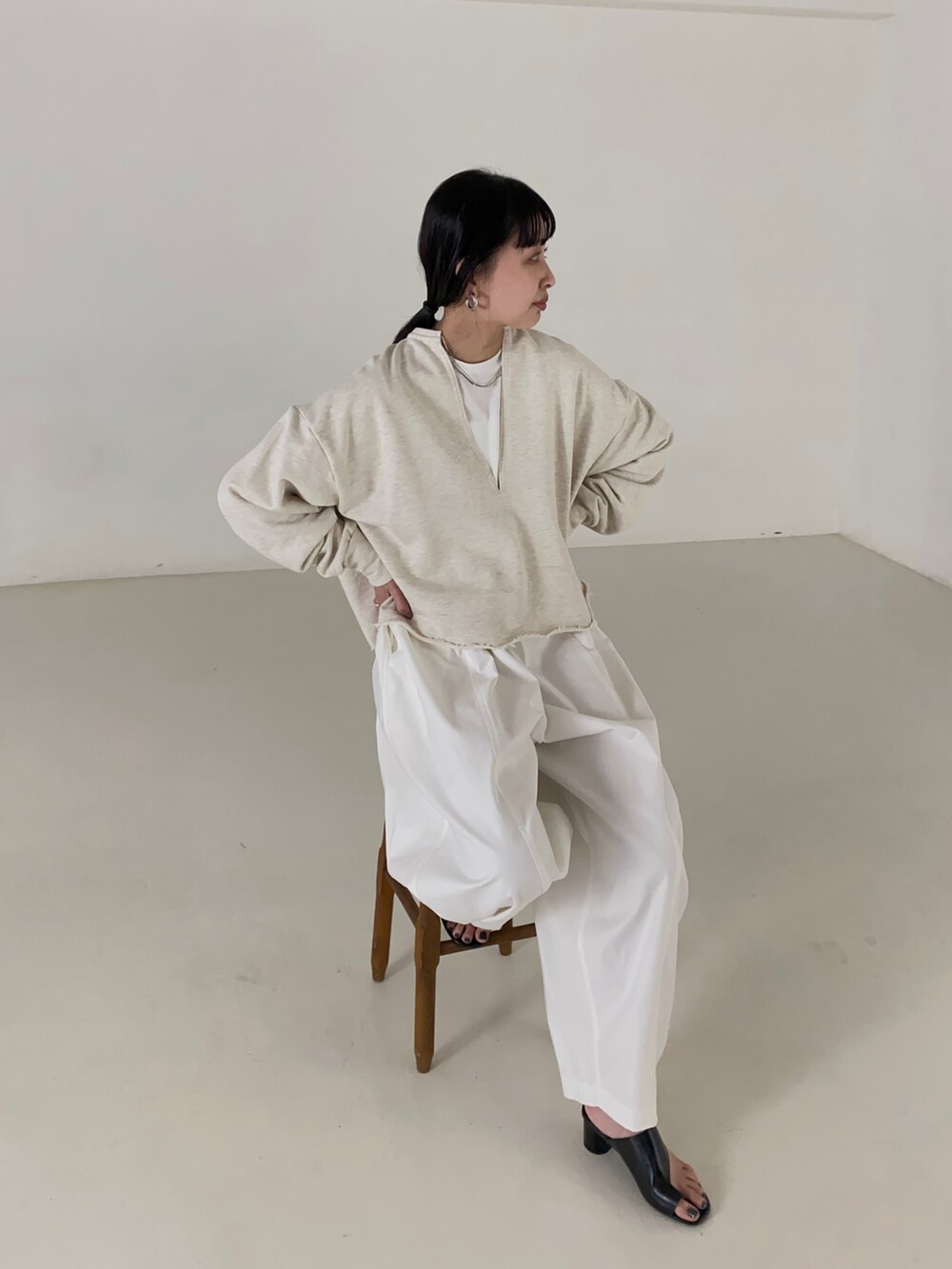 ホワイト系のスウェット、ホワイト系のチノパンツを着用したレディースの春コーディネートの2枚目の写真