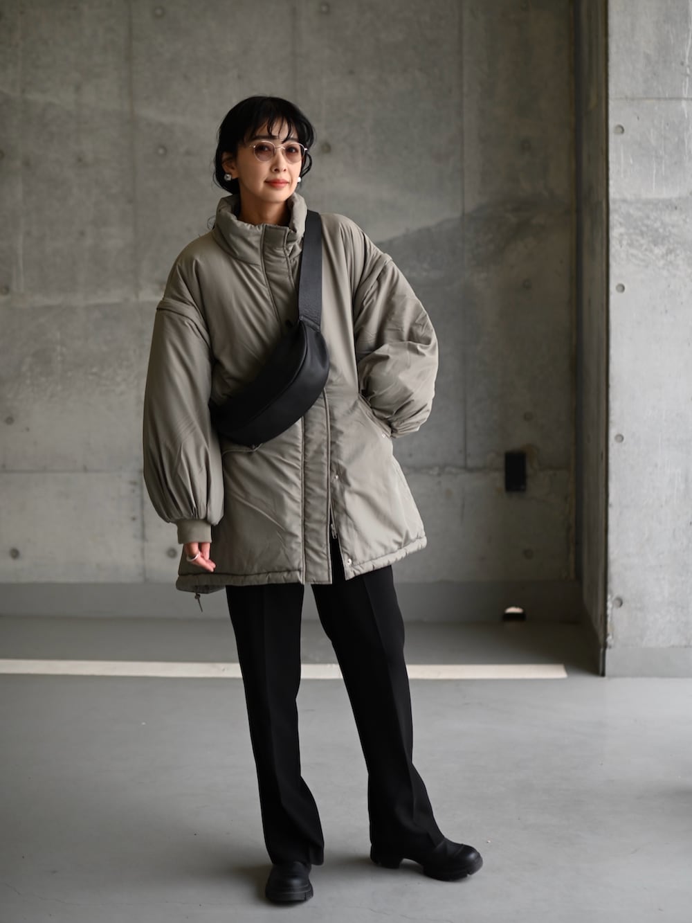 グリーン系のダウンジャケット/コート、ブラック系のその他パンツ、ブラック系のブーツを着用したレディースの秋コーディネートの5枚目の写真