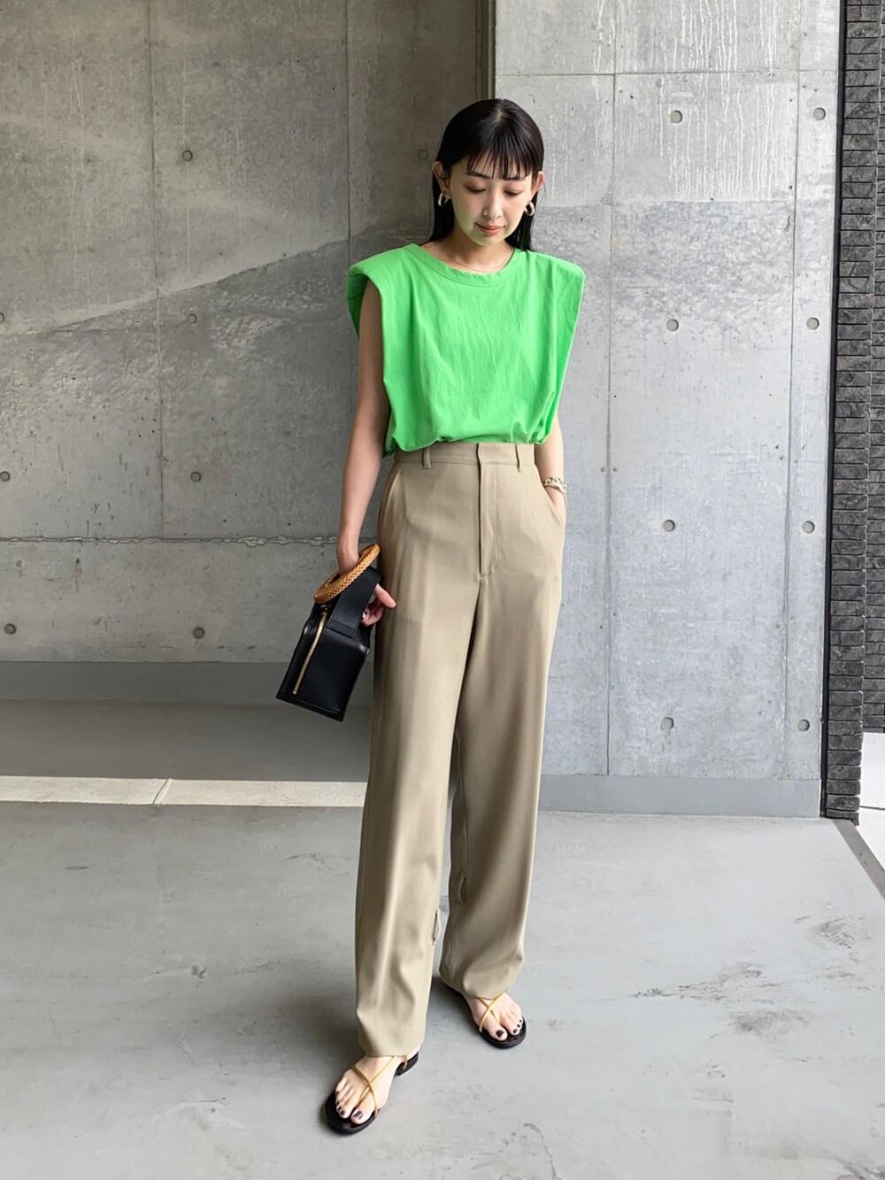 グリーン系のTシャツ/カットソー、ベージュ系のその他パンツ、ブラック系のハンドバッグを着用したレディースの夏コーディネートの4枚目の写真