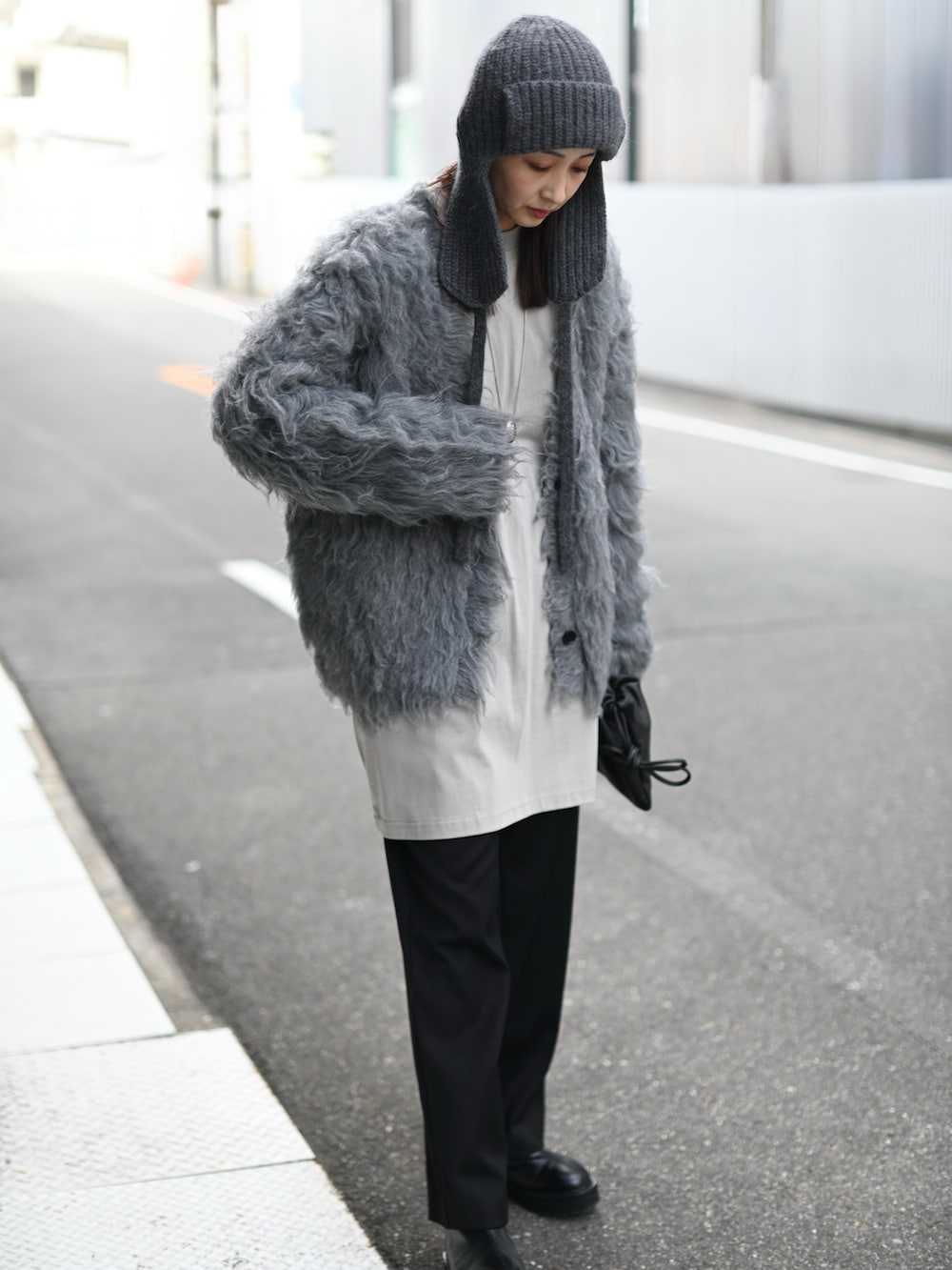 グレー系のカーディガン/ボレロ、ブラック系のスラックス、グレー系のニットキャップ/ビーニーを着用したレディースの冬コーディネートの4枚目の写真