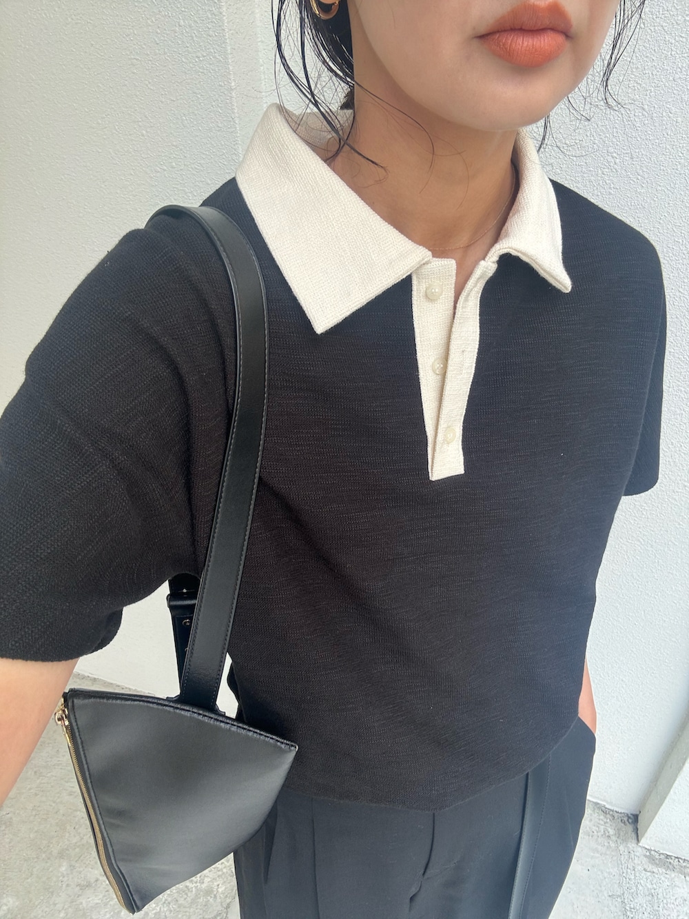 ブラック系のTシャツ/カットソー、ブラック系のスラックス、ブラック系のショルダーバッグを着用したレディースの夏コーディネートの2枚目の写真