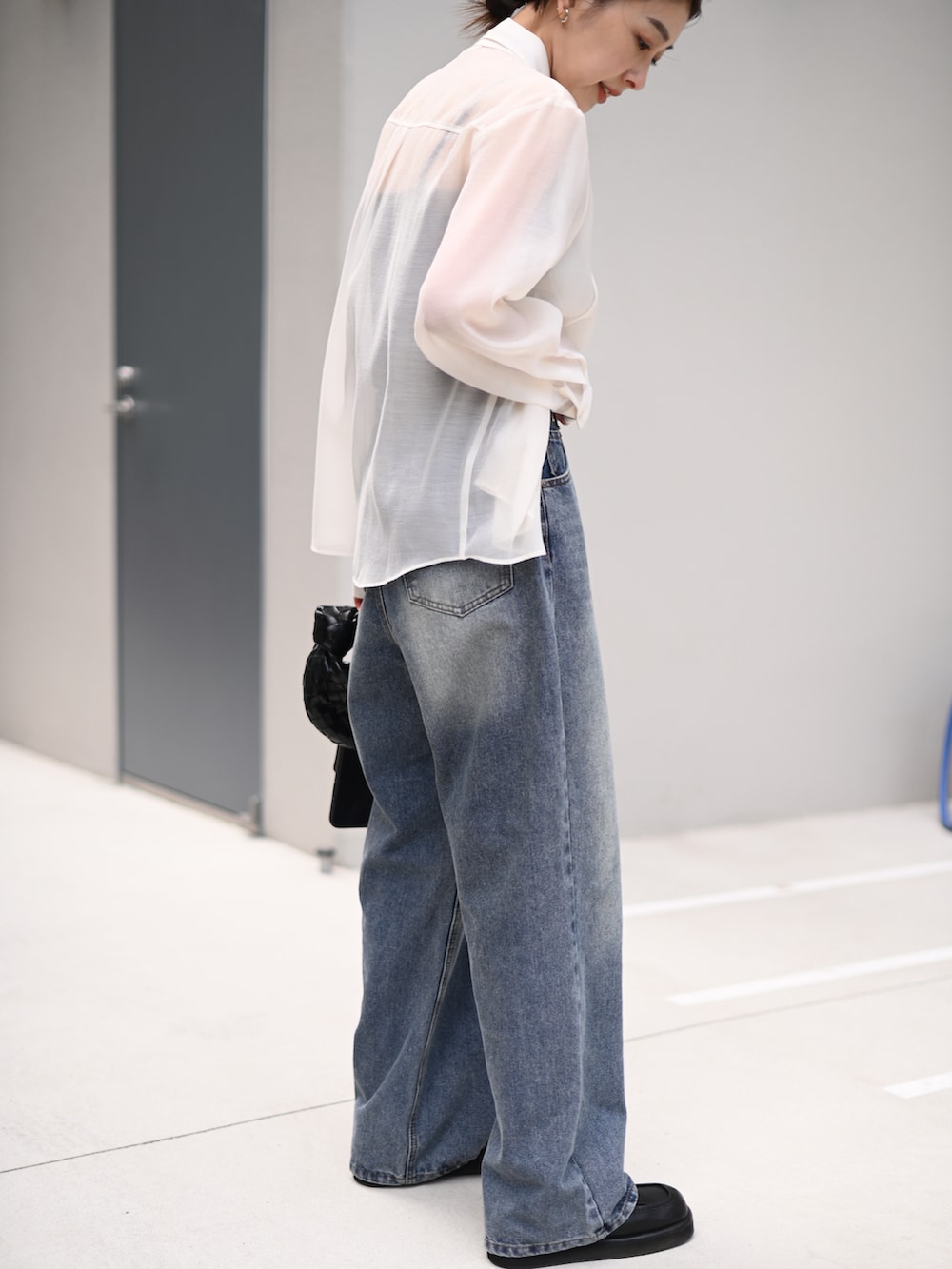 ブルー系のデニムパンツ、ホワイト系のシャツ/ブラウス、ブラック系のネックレスを着用したレディースの春コーディネートの4枚目の写真