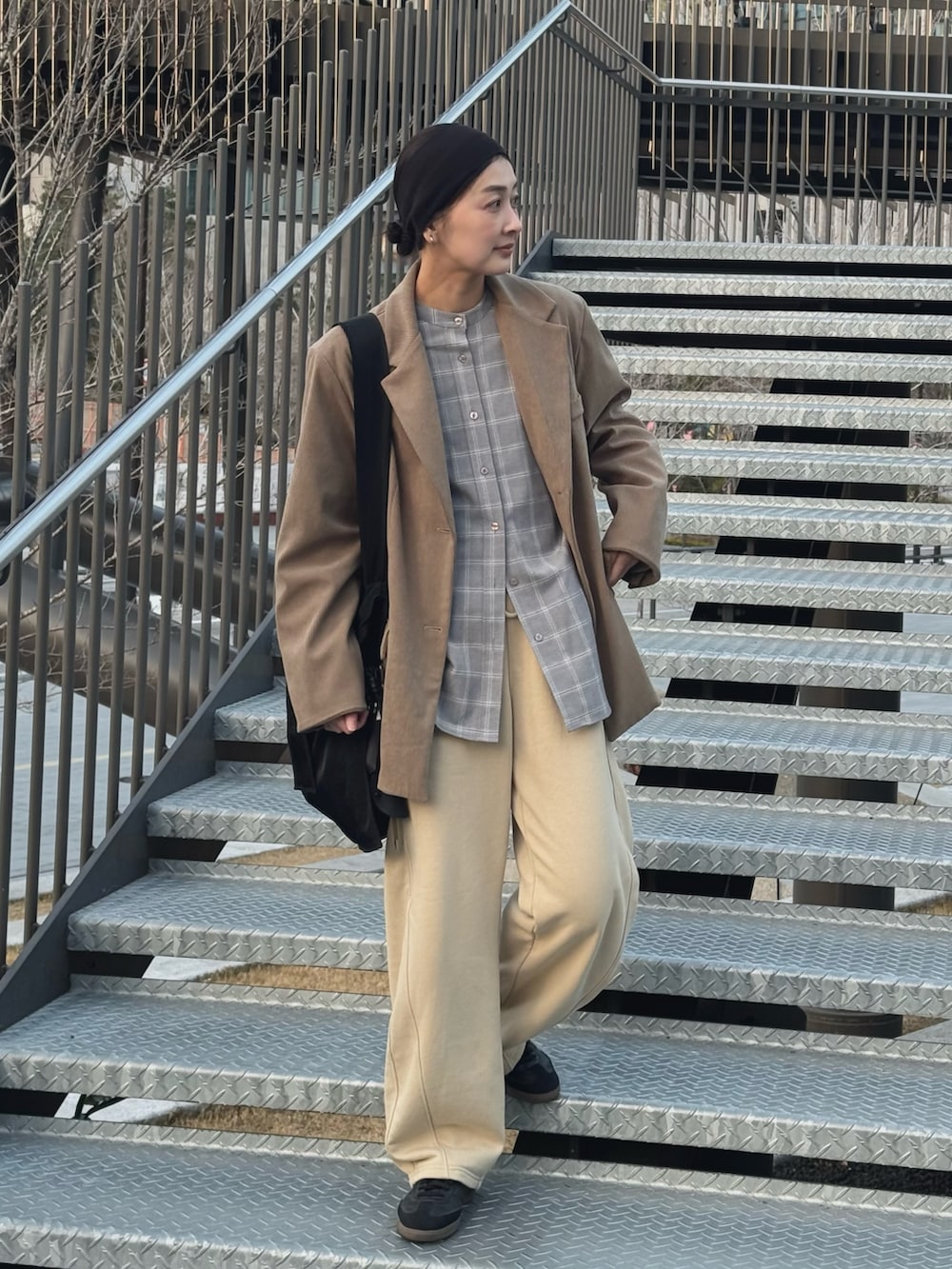 グレー系のシャツ/ブラウス、ベージュ系のスウェットパンツ、ブラック系のトートバッグを着用したレディースの春コーディネートの2枚目の写真