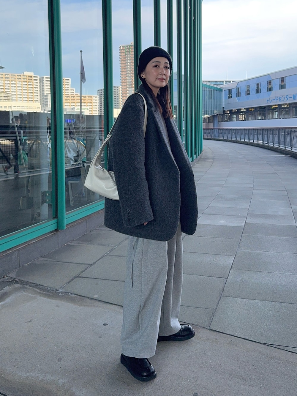 グレー系のシャツ/ブラウス、ホワイト系のショルダーバッグ、ブラック系のローファーを着用したレディースの冬コーディネートの3枚目の写真