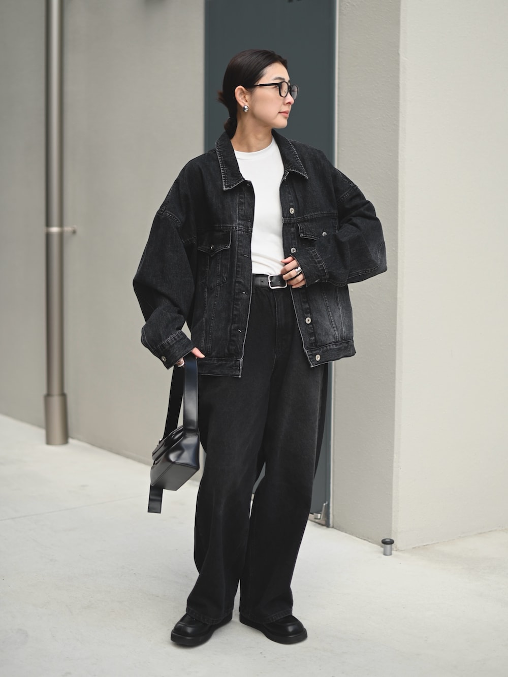 ブラック系のデニムジャケット、ブラック系のデニムパンツ、ホワイト系のTシャツ/カットソーを着用したレディースの春コーディネートの3枚目の写真