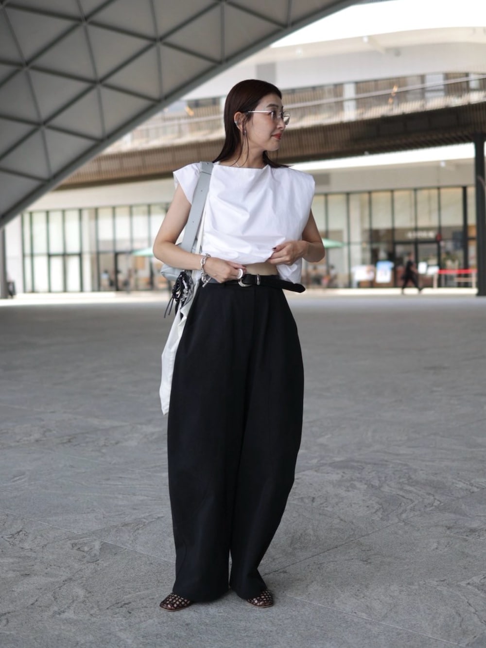 ホワイト系のシャツ/ブラウス、ブラウン系のバレエシューズ、ブラック系のチノパンツを着用したレディースの夏コーディネートの3枚目の写真