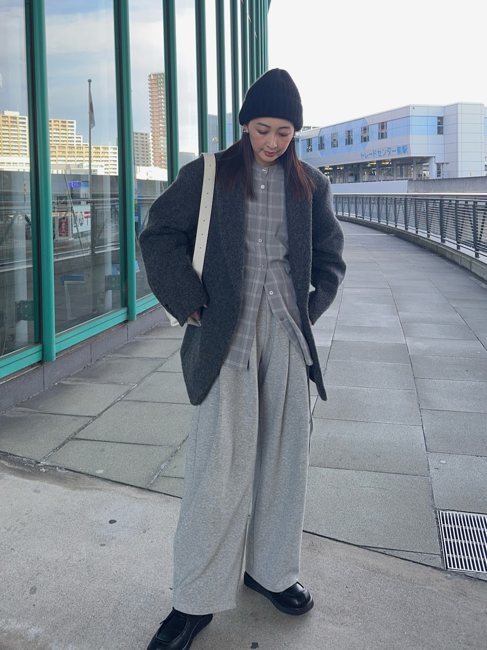 グレー系のシャツ/ブラウス、ホワイト系のショルダーバッグ、ブラック系のローファーを着用したレディースの冬コーディネートの2枚目の写真