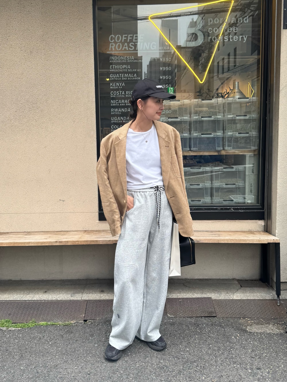 グレー系のスウェットパンツ、ブラック系のスニーカー、ベージュ系のテーラードジャケットを着用したレディースの春コーディネートの5枚目の写真