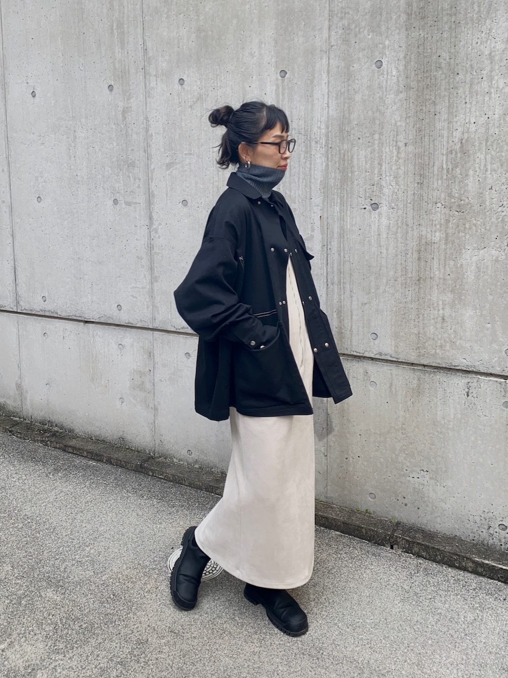 ブラック系のジャケット/アウター、ホワイト系のジャンパースカートを着用したレディースの冬コーディネートの3枚目の写真