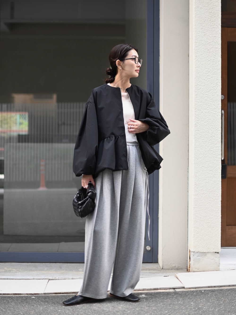 ブラック系のブルゾン、グレー系のスウェットパンツを着用したレディースの秋コーディネートの3枚目の写真