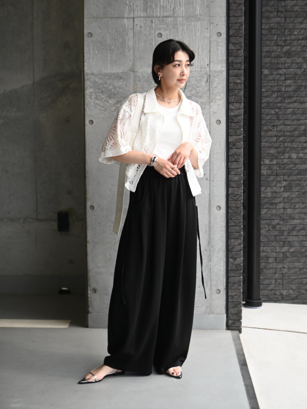 ホワイト系のシャツ/ブラウス、ブラック系のスウェットパンツ、シルバー系のサンダルを着用したレディースの夏コーディネートの2枚目の写真