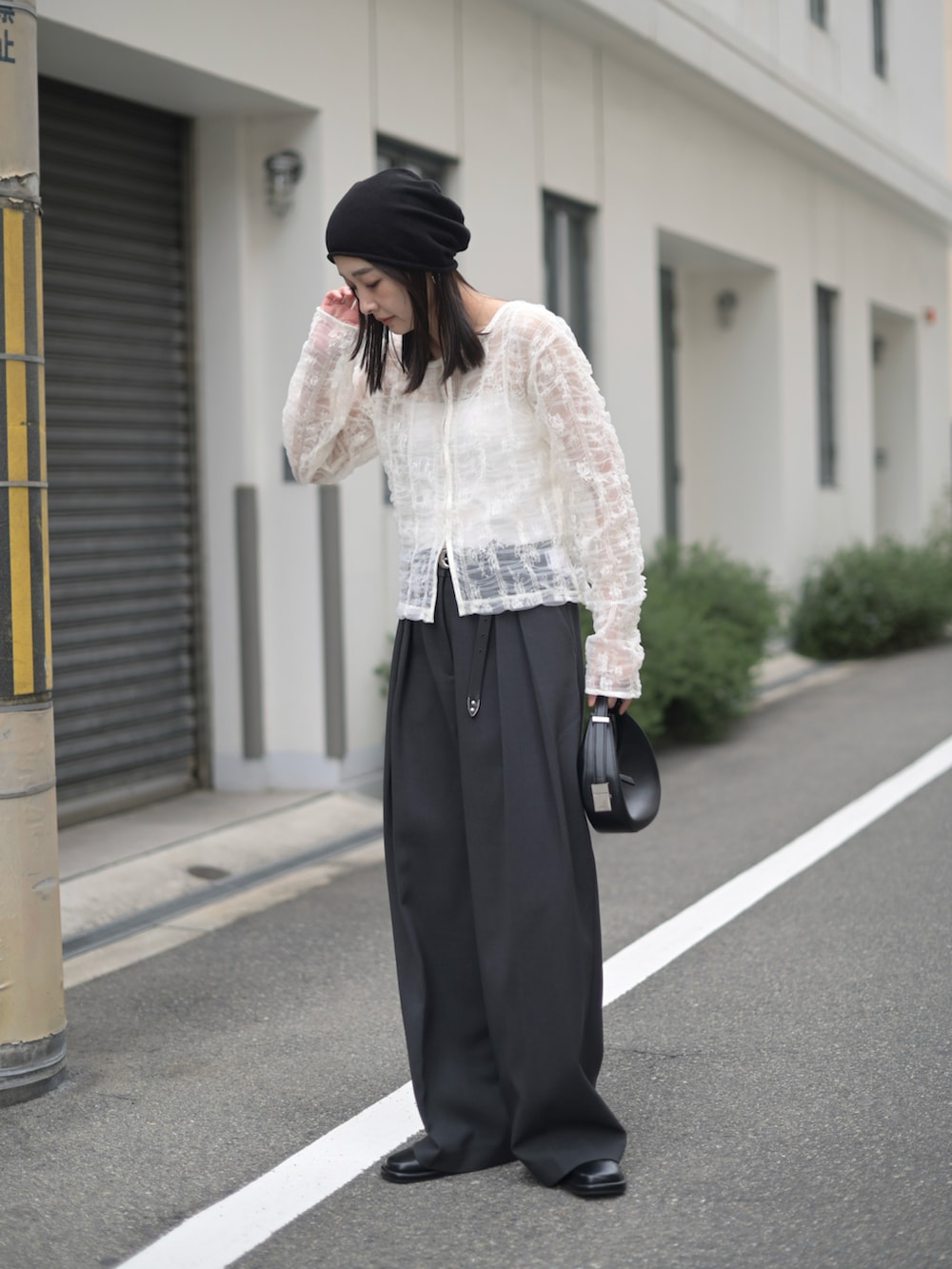 ホワイト系のシャツ/ブラウス、ブラック系のハンドバッグ、ブラック系のベルトを着用したレディースの夏コーディネートの2枚目の写真