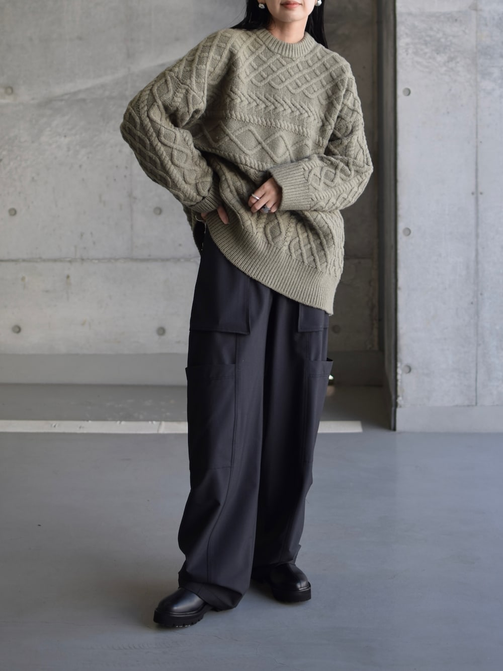 グリーン系のニット/セーター、グリーン系のカーゴパンツ、ブラック系のブーツを着用したレディースの秋コーディネートの4枚目の写真