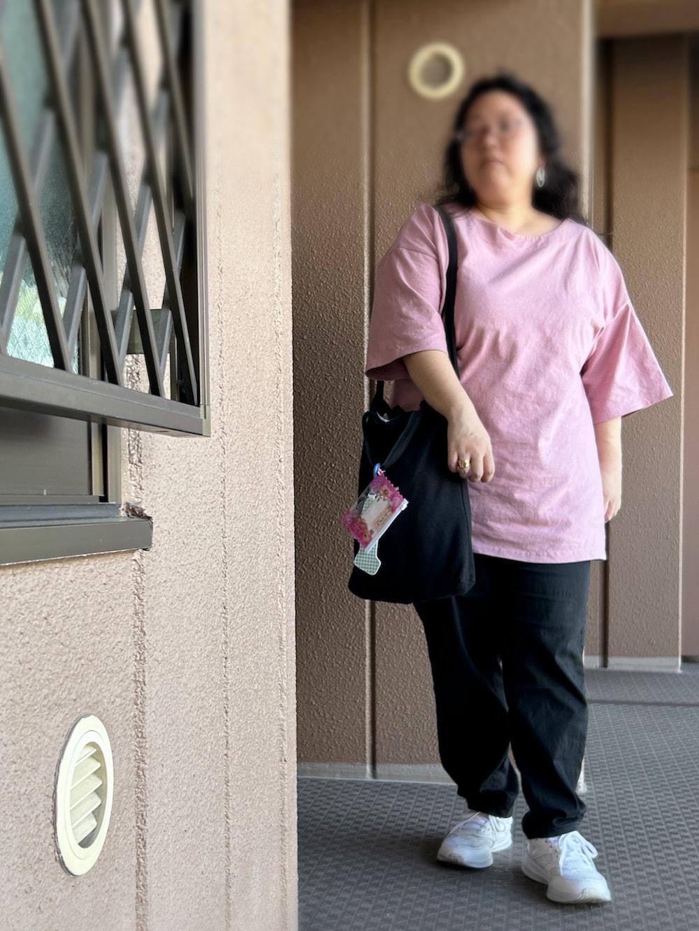 ピンク系のTシャツ/カットソー、ブラック系のその他パンツ、ブラック系のトートバッグを着用したレディースの夏コーディネートの2枚目の写真
