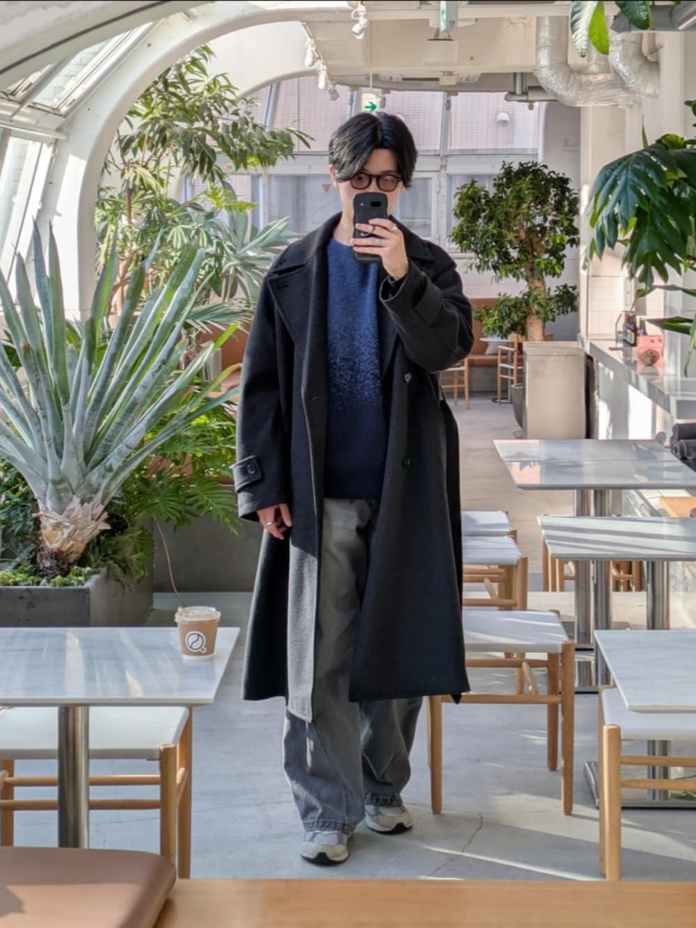 グレー系のその他アウター、ブルー系のニット/セーター、グレー系のデニムパンツを着用したメンズの冬コーディネートの2枚目の写真