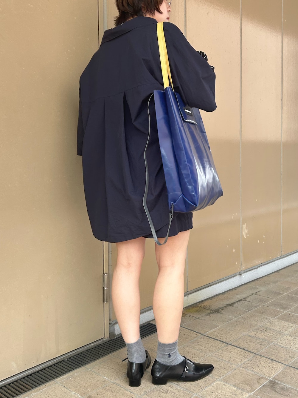 ブルー系のセットアップ、ブラック系のパンプス、ホワイト系のTシャツ/カットソーを着用したレディースの夏コーディネートの2枚目の写真