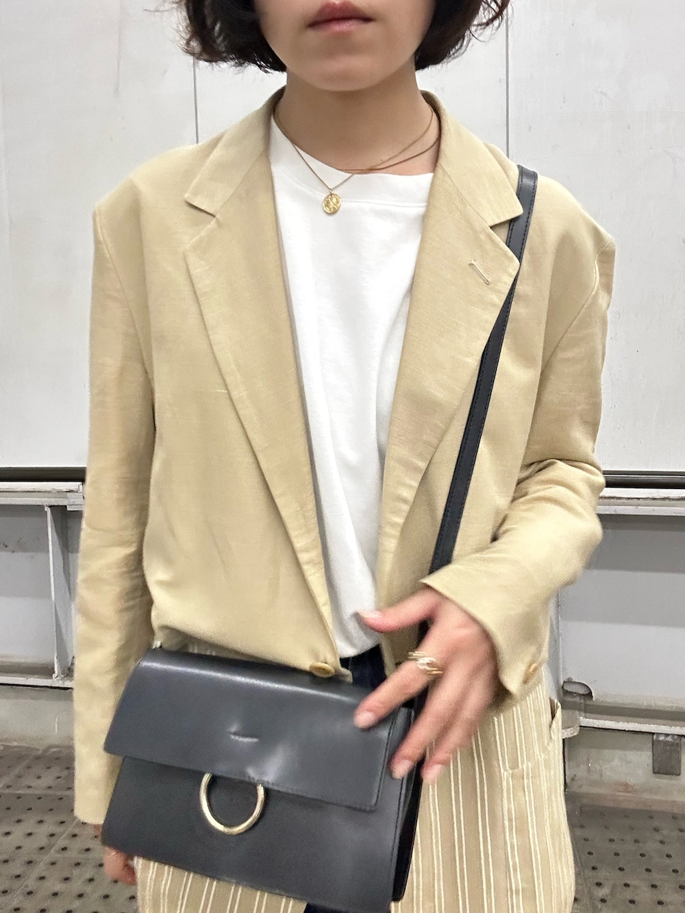 グリーン系のローファー、ホワイト系のTシャツ/カットソー、ブルー系のデニムパンツを着用したレディースの秋コーディネートの2枚目の写真