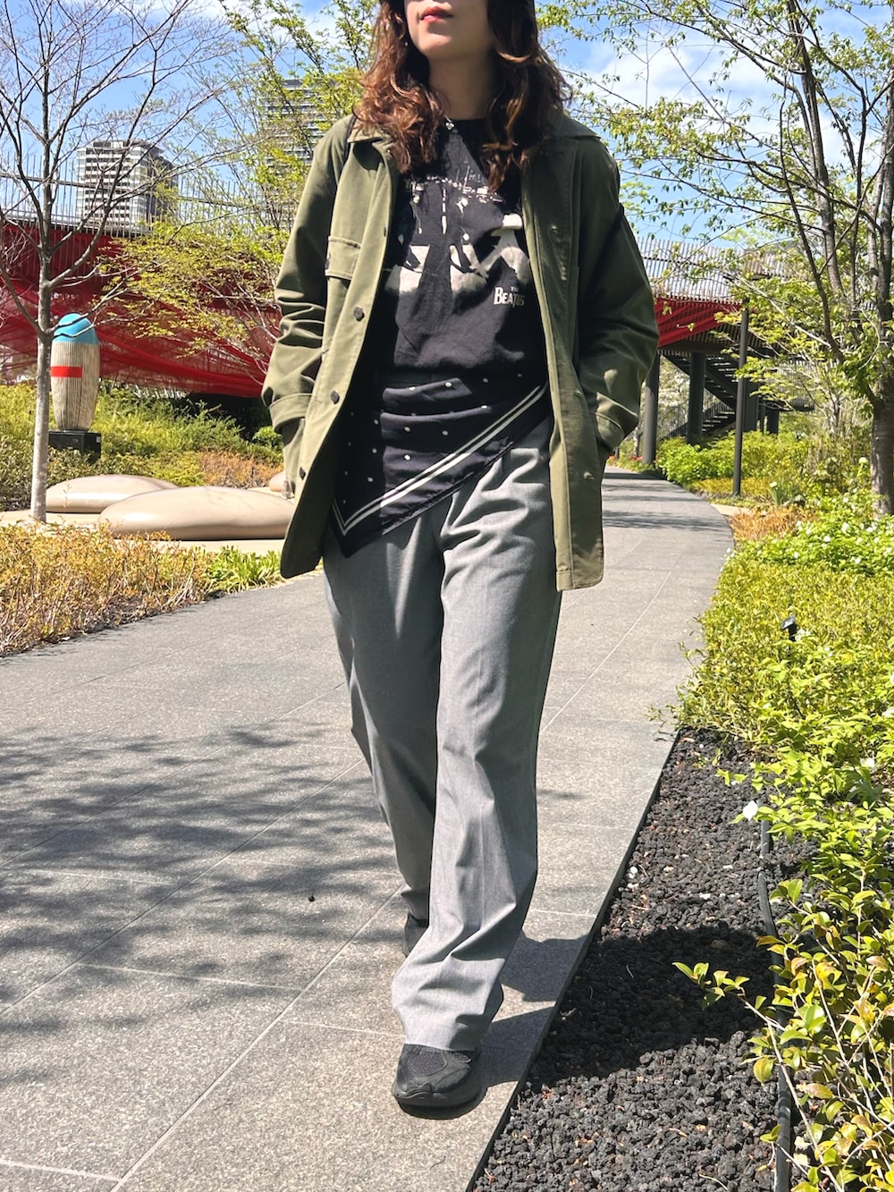 ブラック系のスニーカー、ブラック系のTシャツ/カットソー、グリーン系のテーラードジャケットを着用したレディースの春コーディネートの3枚目の写真
