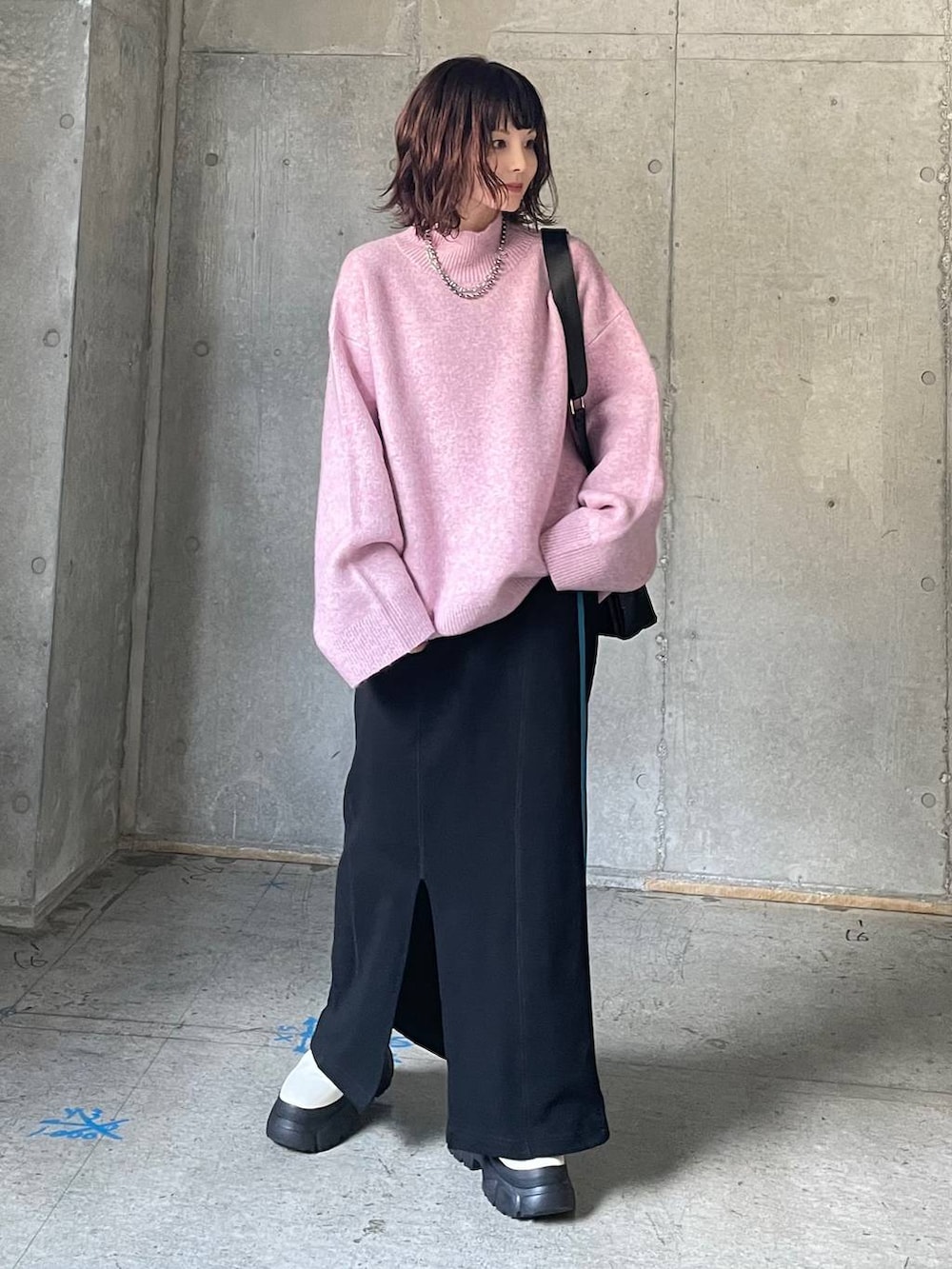 ホワイト系のブーツ、レッド系のニット/セーター、ブラック系のスカートを着用したレディースの秋コーディネートの2枚目の写真